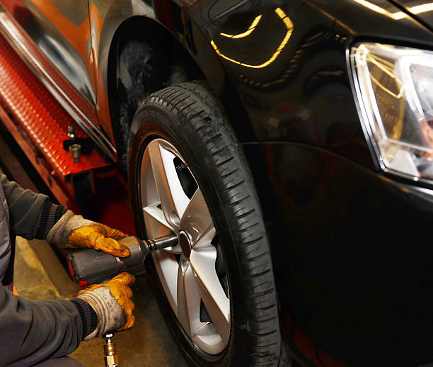 istock Mechanic working on a car tire 174779093