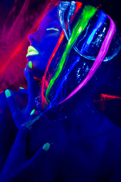 istock Women Portrait with Glowing Multi Colored Hair in black light 174779176