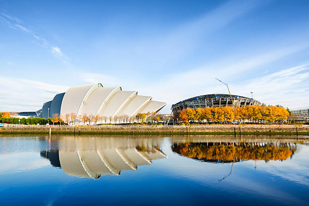 The River Clyde in Glasgow with blue sky Landmarks reflected in the River Clyde in Glasgow: the SECC Armadillo and the Scottish Hydro Arena (under construction). clyde river stock pictures, royalty-free photos & images