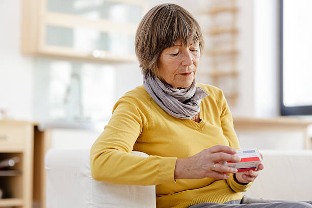 istock Senior woman reading label on medicine 174779783
