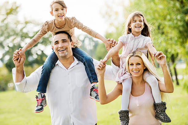 istock Mother and father piggybacking their daughters 174780087