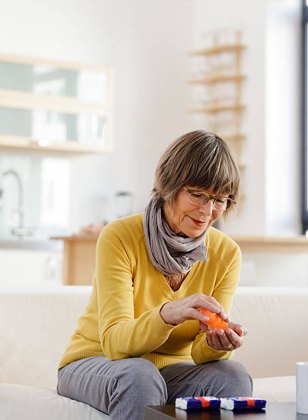 istock Older woman sitting down taking medicine 174780157