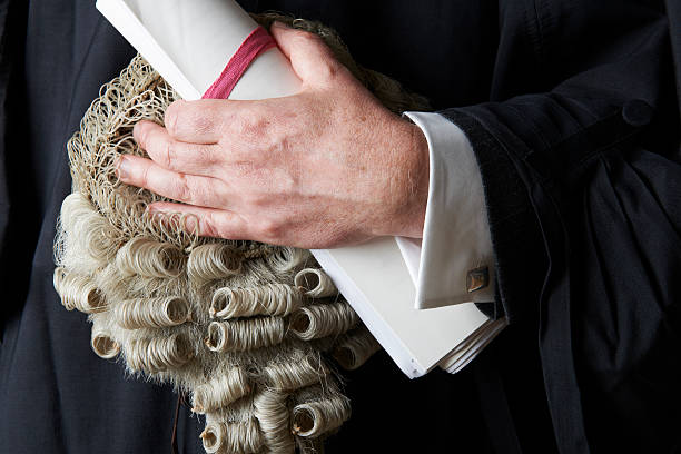 Close Up Of Barrister Holding Wig And Brief Concept to illustrate legal profession slander stock pictures, royalty-free photos & images