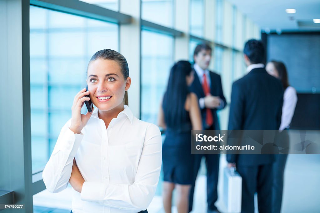 Caucasica donna d'affari al telefono - Foto stock royalty-free di Abbigliamento da lavoro