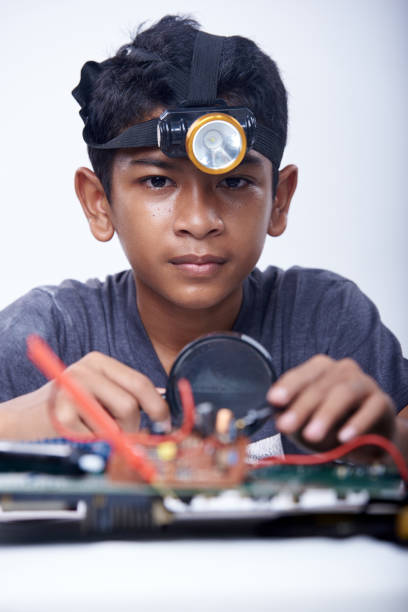 Young engineer boy studying electronic component stock photo