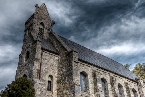 A High Dynamic Range (HDR) rendition of an old stone church in rural Frederick County Maryland.  Dramatic sky highlights the church steeple and cross.For similar photos check out my