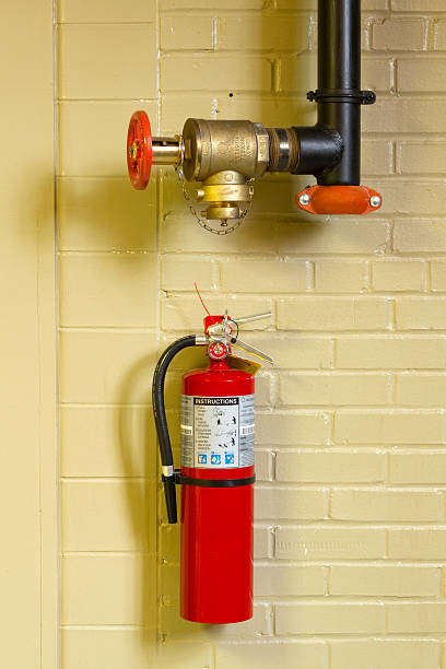istock Red Fire Extinguisher & Emergency Standpipe Hose Valve Interior Wall 174781383