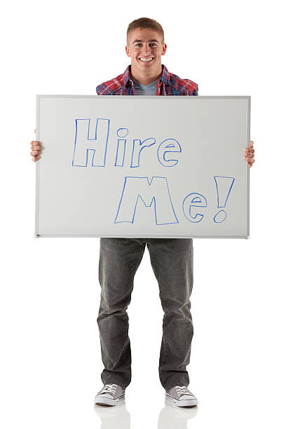 istock Happy young man holding a Hire Me placard 174781487