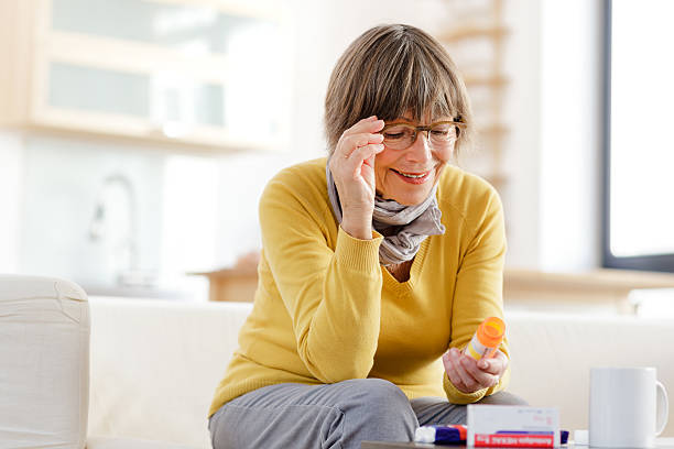 istock Senior woman reading label on medicine 174782508