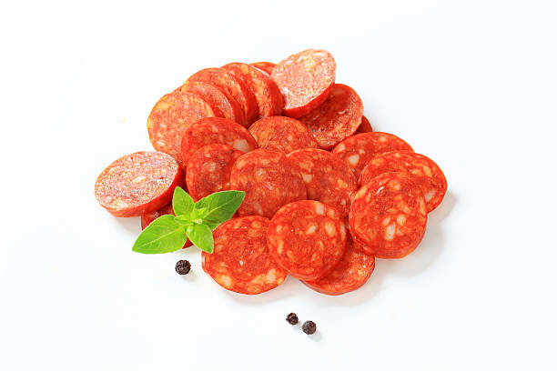 istock Heap of sausage slices isolated on white 174782603