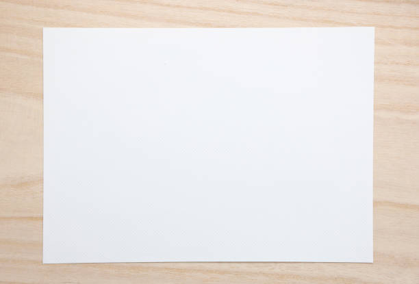 Blank white paper on brown paper background.