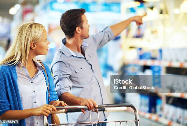 Maybe Its In That Aisle Over Three Stock Photo - Download Image Now - 20-29 Years, Adult, Aisle