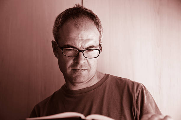 istock Mature caucasian man reading book indoors 174784958