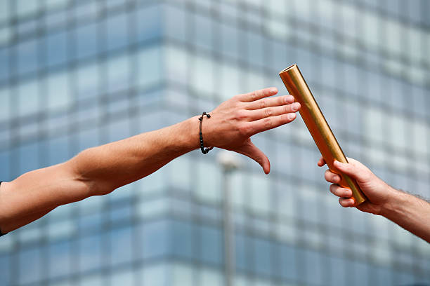 Close-up of a baton exchanging hands