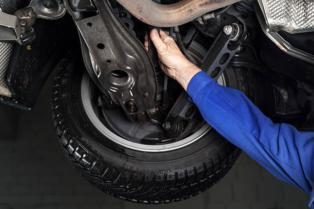 istock Mechanic is checking the shock absorbers of a modern car 174785142