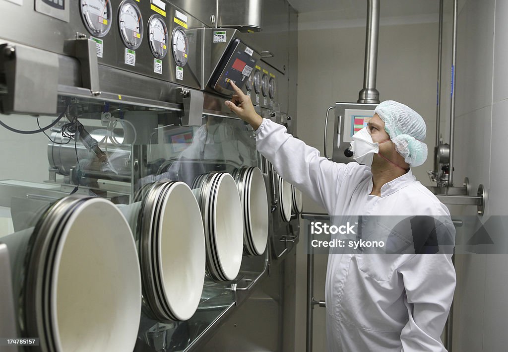 Worker set big glove box machine in pharmaceutical factory Big glove box  machine in pharmaceutical factory Medicine Stock Photo