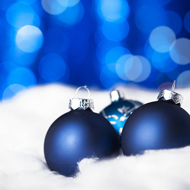 blue christmas balls on snow - marko skrbic stock-fotos und bilder