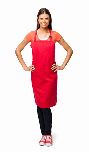 Woman In Red Apron - Isolated Full length portrait of a young woman in red apron with hands on hips. Vertical shot. Isolated on white. apron photos stock pictures, royalty-free photos & images
