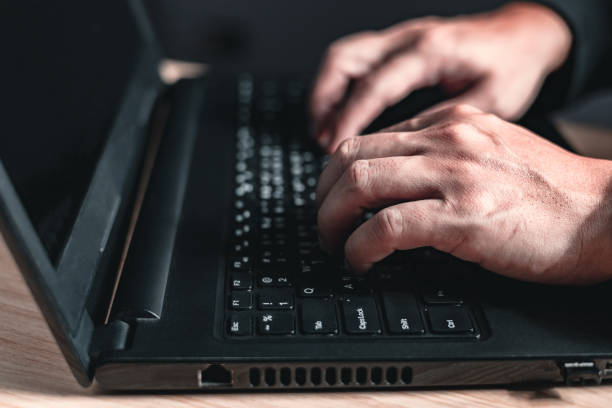 istock close up hand of businessman sit sideways using and typing laptop computer. 1747859251