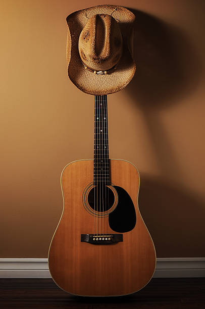 istock Acoustic Guitar and Cowbody Hat 174786425