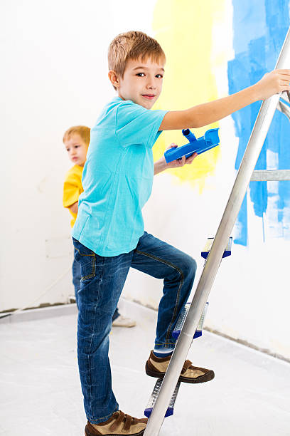 istock Two little boys painting the walls 174786507