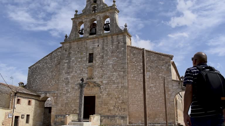 Man walks towards the door of a church in Maderuelo, Spain.