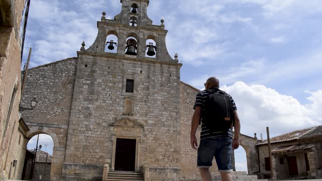 Man walks towards the door of a church in Maderuelo, Spain.