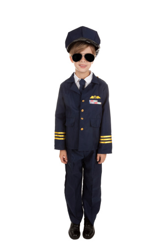 An adorable 8 year old boy dressed in a pilot costume.