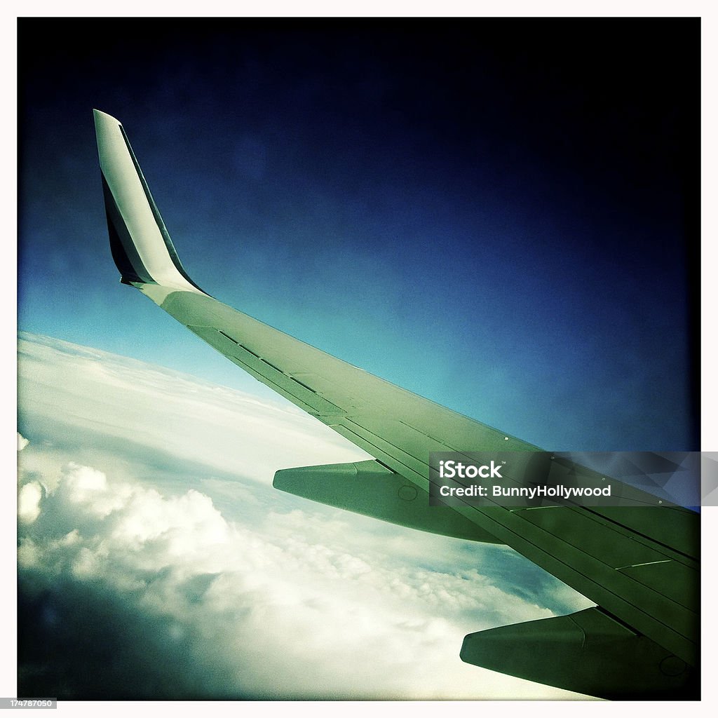 getting away view from a jet window flying in friendly skies above puffy white clouds Achievement Stock Photo
