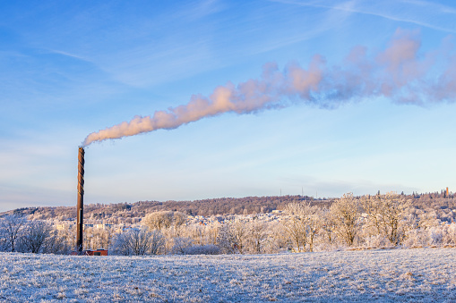 Frosty winter day with smoke from a chimney