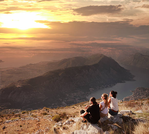 istock Friends watching the sunset on mountain top 174788140