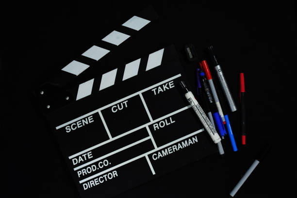 istock Clapperboard and stationery on black background 1747881580
