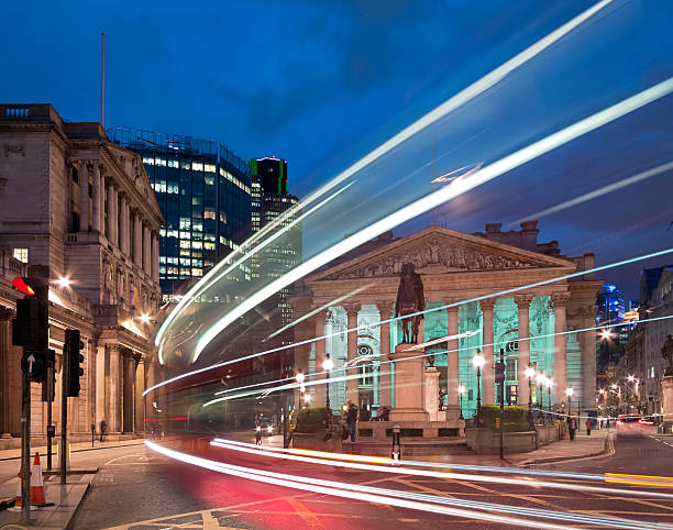 Bank of England in the City of London "A bus driving past the statue of the Duke of Wellington in front of the Royal Exchange. The Bank Of England to the left. London, UK." bank of england stock pictures, royalty-free photos & images