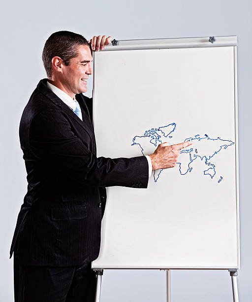 istock Smiling, suited man pointing to Europe on hand-drawn map 174788783
