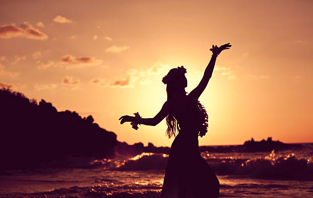 Beautiful Young Hula Dancer Young Hula Dancer posing for the camera seaside at sunset time backlit.Image is processed from a 16 bit RAW file and profiled in ProPhoto RGB. All my images are professionally retouched.More from this series: hula dancer stock pictures, royalty-free photos & images