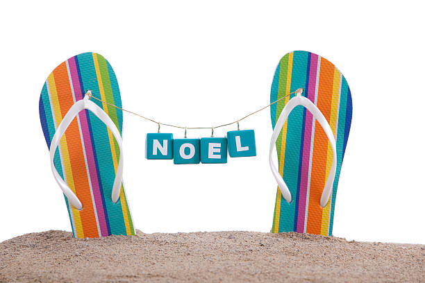 istock Noel Christmas Blocks Hanging From Flip Flops on a Beach 174788953