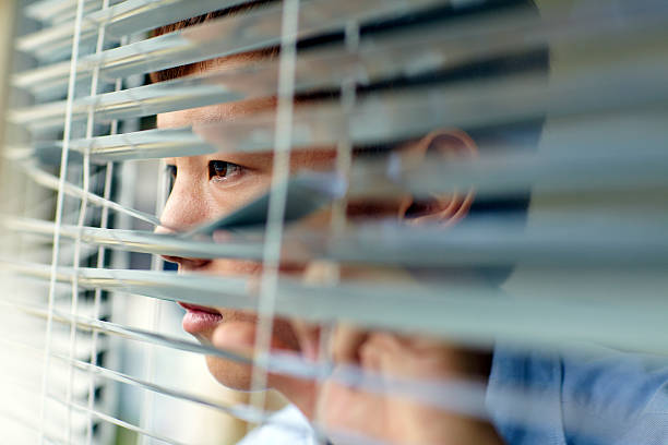 istock young man looking out of the window and thinking 174789110