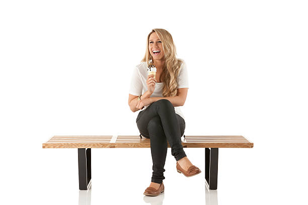 Woman sitting on a bench with an icecream