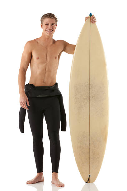 istock Happy male surfer standing with a surfboard 174790732