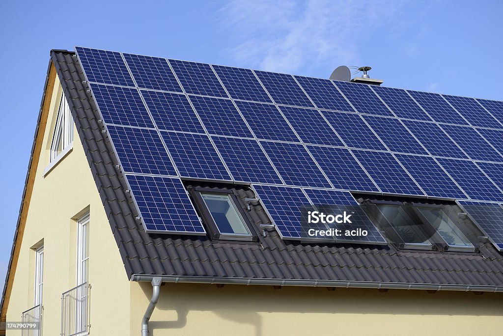 New solar panels on the roof Solar panels on the roof of a new one- family house. Dormer Stock Photo