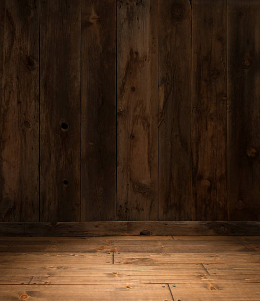 Empty Western Barn wood wall with plank floor spotlit stock photo