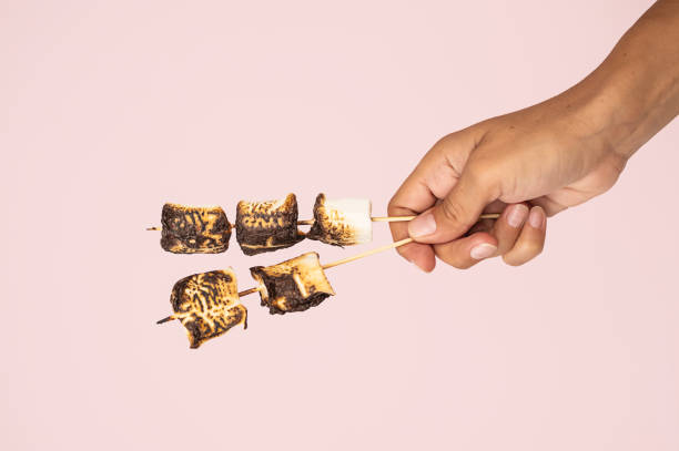 istock Hand holding toasted marshmallows on skewers. 1747912242