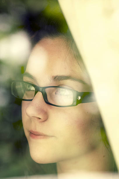 istock Teenage looking through window 174791270