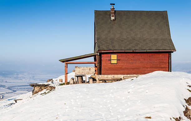 istock Red mountain cottage on a snow top 174792032