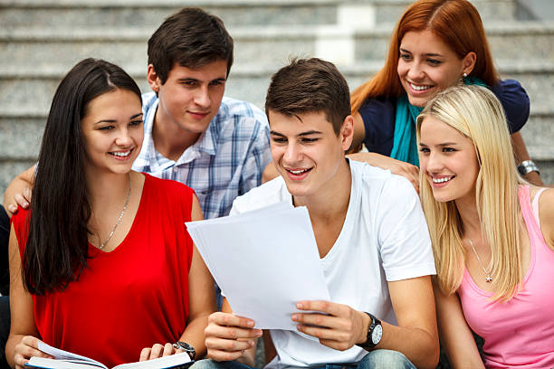 istock Group of university students studying together outdoors 174792462