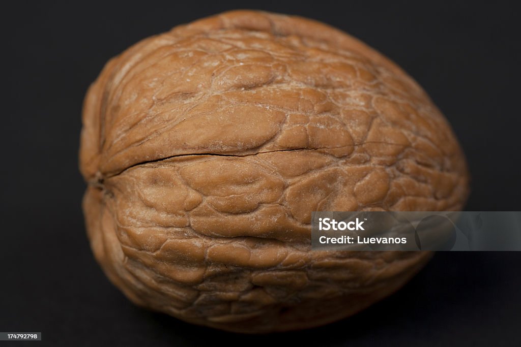 Walnut Macro shot of a walnut against a black background. Visit some of these other fine collections. Black Background Stock Photo