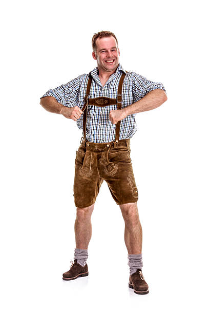 Bavarian / Austrian Man Posing for Fun Bavarian/Austrian man dressed in traditional lederhosen, isolated on white background.     Lederhosen stock pictures, royalty-free photos & images