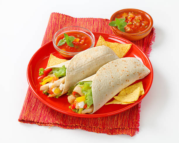 mexican fajitas (tortilla wraps) on a red plate