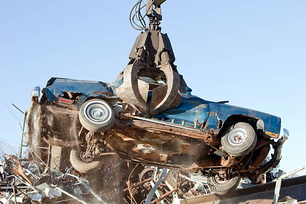 istock Salvage Yard Grappling Claw Gripping Scrap Car 174794202