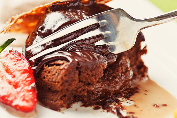 istock Mouthwatering view of hot chocolate pudding being sliced, oozing sauce 174794330